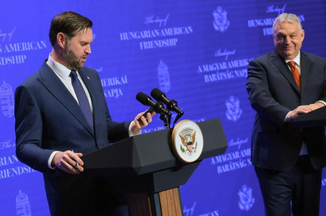 US Vice President JD Vance (L) looks at his phone and comments about an unread message from US Special Envoy Steve Witkoff, as he is asked a question about the US-Israel conflict with Iran, while he and Hungarian Prime Minister Viktor Orban address a joint press conference at the Carmelite Monastery of Buda, seat of the Hungarian premier, in Budapest on April 7, 2026. US Vice President JD Vance arrived in Hungary to deliver the US President's support to his ally, nationalist Prime Minister Viktor Orban, ahead of tightly contested parliamentary elections scheduled for April 12, 2026. (Photo by Jonathan Ernst / POOL / AFP)