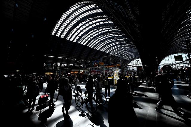 Passengers walk on a platform at the main railway station in Frankfurt am Main, western Germany, on April 7, 2026. (Photo by Kirill KUDRYAVTSEV / AFP)