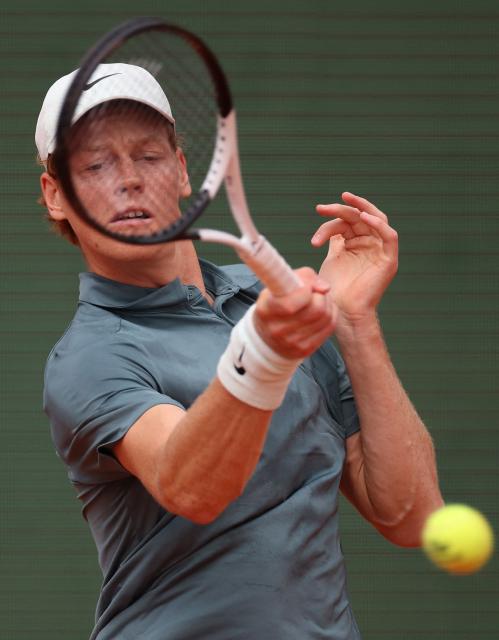 Italy's Jannik Sinner plays a backhand return to France's Ugo Humbert during the Monte Carlo ATP Masters Series Tournament round of 64 tennis match on Court Rainier III at the Monte-Carlo Country Club in Roquebrune-Cap-Martin, south-eastern France on April 7, 2026. (Photo by Valery HACHE / AFP)