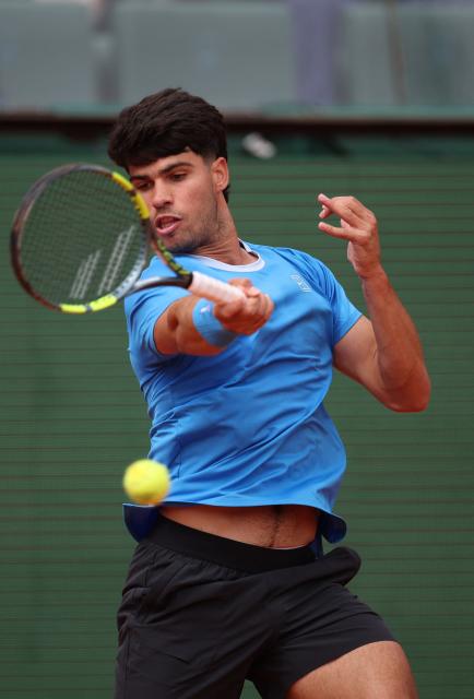 Spain's Carlos Alcaraz plays a forehand return to Argentina's Sebastian Baez during the Monte Carlo ATP Masters Series Tournament round of 64 tennis match on Court Rainier III at the Monte-Carlo Country Club in Roquebrune-Cap-Martin, south-eastern France on April 7, 2026. (Photo by Valery HACHE / AFP)