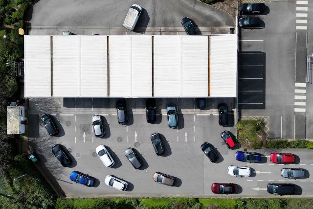An aerial view shows vehicles queuing for fuel at a branch of retail warehouse "Costco" in Liverpool, north west England on April 7, 2026. The war in the Middle East, now in its second month, has caused a record monthly rise in petrol and diesel prices in the United Kingdom. (Photo by Paul ELLIS / AFP)