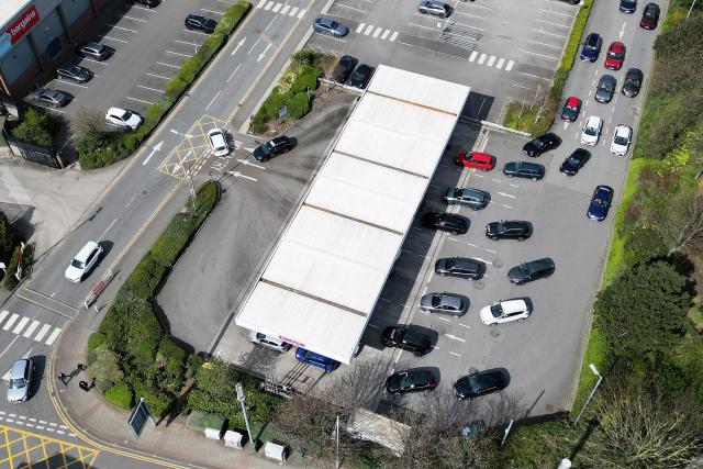 An aerial view shows vehicles queuing for fuel at a branch of retail warehouse "Costco" in Liverpool, north west England on April 7, 2026. The war in the Middle East, now in its second month, has caused a record monthly rise in petrol and diesel prices in the United Kingdom. (Photo by Paul ELLIS / AFP)