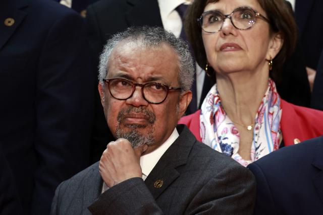 World Health Organization (WHO) Director-General Tedros Adhanom Ghebreyesus (L) attends a family photo during the "One Health Summit" high-level meeting session in Lyon, southern France on April 7, 2026, on the occasion of World Health Day. (Photo by Christophe PETIT TESSON / POOL / AFP)