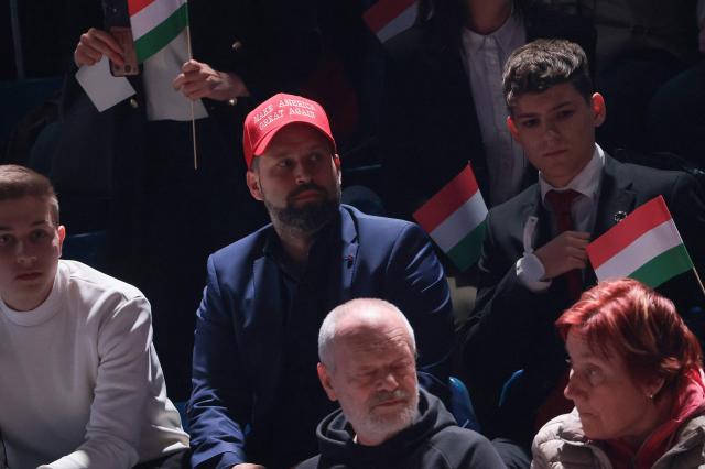 A person wears a MAGA (Make America Great Again) hat as they attend a rally of Hungarian Prime Minister Viktor Orban supported by US Vice President JD Vance (neither in picture) in Budapest on April 7, 2026. US Vice President JD Vance is in Hungary to deliver the US President's support to his ally, nationalist Prime Minister Viktor Orban, ahead of tightly contested parliamentary elections scheduled for April 12, 2026. (Photo by Jonathan Ernst / POOL / AFP)