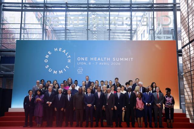 France's President Emmanuel Macron (C), world leaders and health experts attend a family photo during the "One Health Summit" high-level meeting session in Lyon, southern France on April 7, 2026, on the occasion of World Health Day. (Photo by Christophe PETIT TESSON / POOL / AFP)
