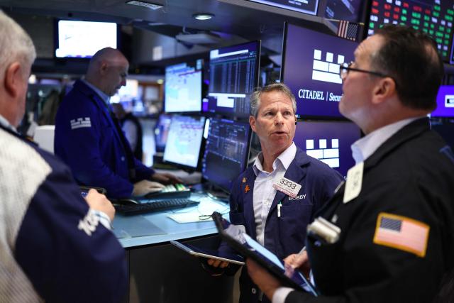 Traders work on the floor of the New York Stock Exchange (NYSE) at the opening bell in New York City on April 7, 2026. Oil prices jumped Tuesday and stocks fell after US-Israeli strikes on the key Iranian oil export terminal of Kharg island, with investors bracing for US President Donald Trump's looming deadline for Iran to reopen the Strait of Hormuz or face devastating attacks. (Photo by CHARLY TRIBALLEAU / AFP)