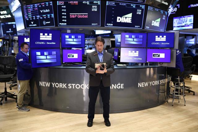 Traders work on the floor of the New York Stock Exchange (NYSE) at the opening bell in New York City on April 7, 2026. Oil prices jumped Tuesday and stocks fell after US-Israeli strikes on the key Iranian oil export terminal of Kharg island, with investors bracing for US President Donald Trump's looming deadline for Iran to reopen the Strait of Hormuz or face devastating attacks. (Photo by CHARLY TRIBALLEAU / AFP)