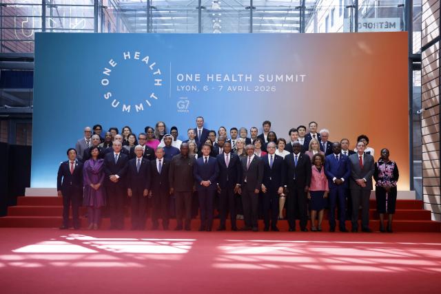 France's President Emmanuel Macron (C), world leaders and health experts attend a family photo during the "One Health Summit" high-level meeting session in Lyon, southern France on April 7, 2026, on the occasion of World Health Day. (Photo by Christophe PETIT TESSON / POOL / AFP)