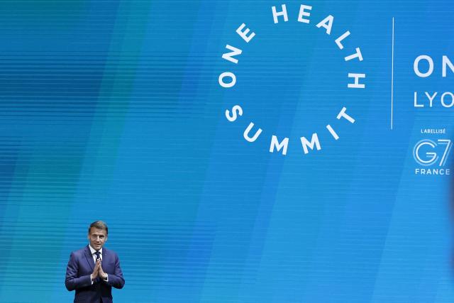 France's President Emmanuel Macron arrives to deliver his speech during the opening session of "One Health Summit" high-level meeting in Lyon, southern France on April 7, 2026, on the occasion of World Health Day. (Photo by Christophe PETIT TESSON / POOL / AFP)
