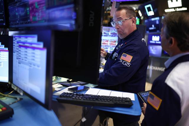Traders work on the floor of the New York Stock Exchange (NYSE) at the opening bell in New York City on April 7, 2026. Oil prices jumped Tuesday and stocks fell after US-Israeli strikes on the key Iranian oil export terminal of Kharg island, with investors bracing for US President Donald Trump's looming deadline for Iran to reopen the Strait of Hormuz or face devastating attacks. (Photo by CHARLY TRIBALLEAU / AFP)