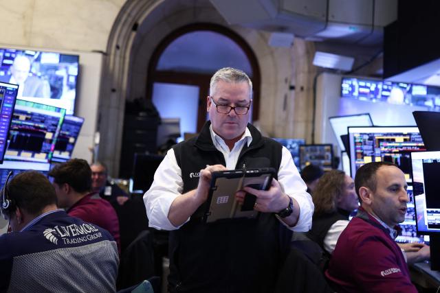 Traders work on the floor of the New York Stock Exchange (NYSE) at the opening bell in New York City on April 7, 2026. Oil prices jumped Tuesday and stocks fell after US-Israeli strikes on the key Iranian oil export terminal of Kharg island, with investors bracing for US President Donald Trump's looming deadline for Iran to reopen the Strait of Hormuz or face devastating attacks. (Photo by CHARLY TRIBALLEAU / AFP)