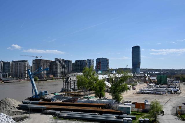 This photograph shows the construction site of a new bridge where a crane collapsed, on the banks of the River Sava in Belgrade on April 7, 2026. The collapse of the 350-ton metal structure left one person dead while three others were injured, according to the Serbian Interior Ministry and Serbian media. The circumstances surrounding the incident are currently under investigation by the authorities. (Photo by Andrej ISAKOVIC / AFP)