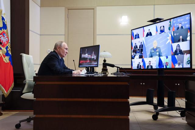 In this pool photograph distributed by the Russian state agency Sputnik, Russia's President Vladimir Putin chairs an operational meeting on flooding situation in Dagestan via a videoconference at the Novo-Ogaryovo state residence outside Moscow on April 7, 2026. (Photo by Alexander KAZAKOV / POOL / AFP)