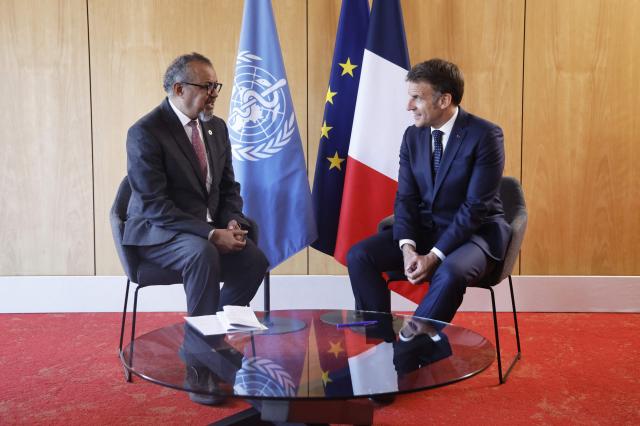 France's President Emmanuel Macron (R) meets with World Health Organization (WHO) Director-General Tedros Adhanom Ghebreyesus on the sideline of "One Health Summit" high-level meeting in Lyon, southern France on April 7, 2026. (Photo by Christophe PETIT TESSON / POOL / AFP)