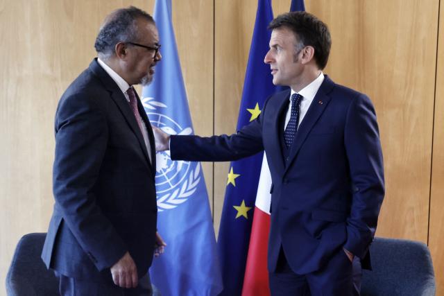 France's President Emmanuel Macron (R) meets with World Health Organization (WHO) Director-General Tedros Adhanom Ghebreyesus on the sideline of "One Health Summit" high-level meeting in Lyon, southern France on April 7, 2026. (Photo by Christophe PETIT TESSON / POOL / AFP)