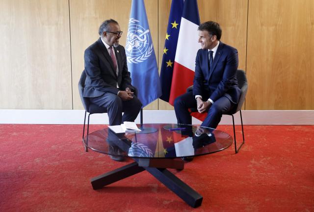 France's President Emmanuel Macron (R) meets with World Health Organization (WHO) Director-General Tedros Adhanom Ghebreyesus on the sideline of "One Health Summit" high-level meeting in Lyon, southern France on April 7, 2026. (Photo by Christophe PETIT TESSON / POOL / AFP)
