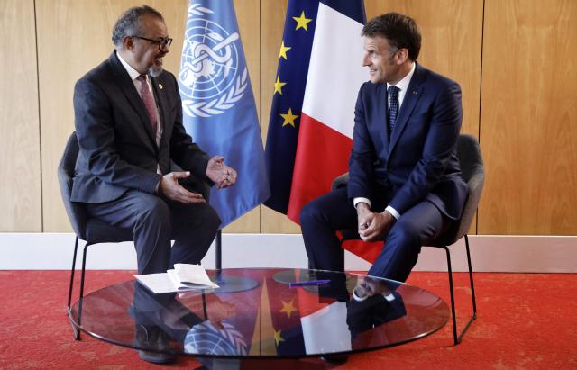France's President Emmanuel Macron (R) meets with World Health Organization (WHO) Director-General Tedros Adhanom Ghebreyesus on the sideline of "One Health Summit" high-level meeting in Lyon, southern France on April 7, 2026. (Photo by Christophe PETIT TESSON / POOL / AFP)