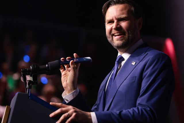 US Vice President JD Vance holds a mobile phone while on a call with US President Donald Trump to a microphone during a "Day of Friendship" event with Hungarian Prime Minister Viktor Orban (not in picture) at MTK Sportpark in Budapest, Hungary on April 7, 2026. US Vice President JD Vance is in Hungary to deliver the US President's support to his ally, nationalist Prime Minister Viktor Orban, ahead of tightly contested parliamentary elections scheduled for April 12, 2026. (Photo by Jonathan Ernst / POOL / AFP)