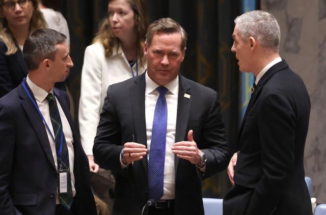 (L/R) Interim UK Ambassador to the UN Archie Young, US Ambassador to the UN Mike Waltz, and French Ambassador to the UN Jerome Bonnafont speak with each other before the start of a United Nations Security Council meeting on Iran and the Middle East at UN headquarters in New York on April 7, 2026. The UN Security Council is expected to vote Tuesday on a watered-down resolution calling for the unblocking of the Strait of Hormuz -- far from the sponsoring Gulf countries' initial goal of obtaining clearance to free it by force. The vote comes just hours before Donald Trump's 8:00 pm (midnight GMT) deadline for Iran to make a deal or face the US military destroying its power plants and bridges. (Photo by TIMOTHY A. CLARY / AFP)