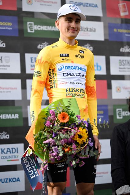 Team Decathlon CMA CGM's French rider Paul Seixas stands on the podium retaining the overall ranking leader's yellow jersey after  winning the second stage of the Basque Country's Itzulia cycling tour, a 164.1 km race between Pamplona and Mendukilo cave, near Astitz, on April 7, 2026. French youngster Paul Seixas stretched his overall lead at the Tour of the Basque Country today after a powerful breakaway on the final main climb of the second stage. (Photo by ANDER GILLENEA / AFP)