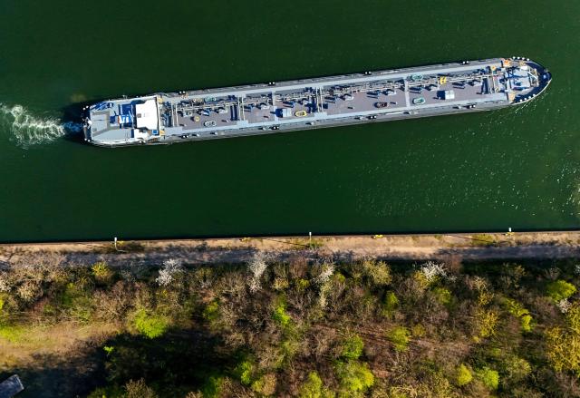 An aerial view shows a tanker near the fuel depot of Aral at the Ruhr Oel petroleum refineries of BP Gelsenkirchen GmbH in Gelsenkirchen, western Germany on April 7, 2026. The Iran war sent oil prices soaring on March 9, 2026 after Tehran, under new leader Mojtaba Khamenei, fired a new barrage of missiles at its Gulf neighbours and signalled that the strategic Strait of Hormuz would likely remain shut.
With the Strait of Hormuz off Iran remaining closed to almost all oil tankers, the price of benchmark crude oil contracts rocketed past $100 a barrel on Monday -- their highest levels since Russia's invasion of Ukraine in 2022 -- before edging back slightly. (Photo by Ina FASSBENDER / AFP)