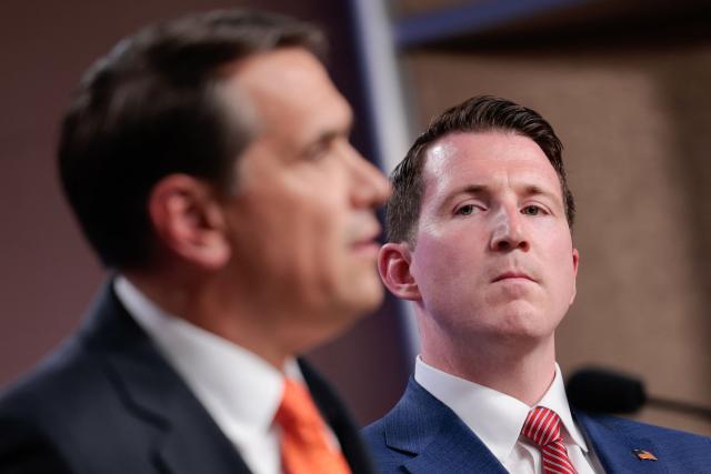 (L/R) US Acting Attorney General Todd Blanche speaks as Assistant Attorney General for the Fraud Division Colin McDonald looks on during a news conference about the Trump administration's anti-fraud efforts at the Department of Justice headquarters in Washington, DC, on April 7, 2026. (Photo by Kent Nishimura / AFP)