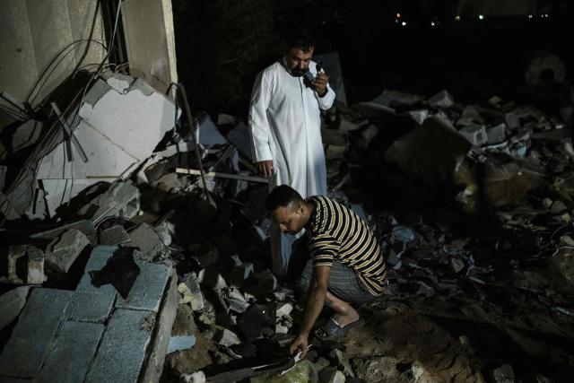 Men inspect the rubble of a house following a strike in Khor al-Zubair, in Iraq's southern province of Basra, on April 7, 2026. A strike in Iraq's southern province of Basra on April 7 killed at least three civilians, a provincial councillor and a security official told AFP. A member of Basra's provincial council said "a house in the city of Khor al-Zubair was struck by what eyewitnesses said was a jet", adding that "neighbours said the house was inhabited by five people, but until now only three bodies have been retrieved". (Photo by Hussein FALEH / AFP)