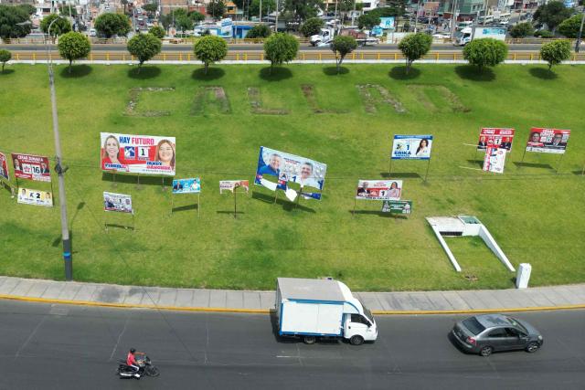 This aerial view shows political advertising in Callao, on the outskirts of Lima, Peru, on April 7, 2026. Peru will hold presidential elections on April 12. (Photo by Luis ROBAYO / AFP)