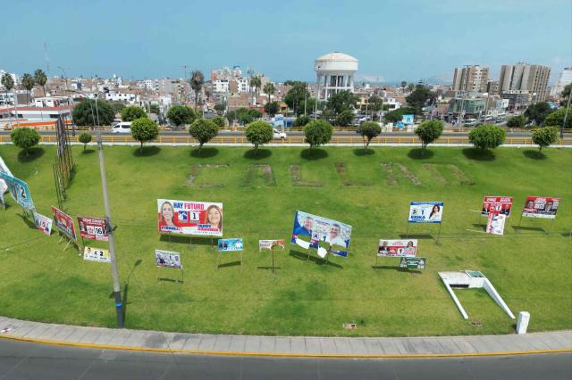 This aerial view shows political advertising in Callao, on the outskirts of Lima, Peru, on April 7, 2026. Peru will hold presidential elections on April 12. (Photo by Luis ROBAYO / AFP)