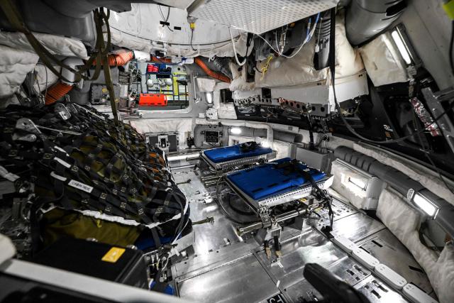 A view through a window of the Orion spacecraft mockup on April 7, 2026 at Johnson Space Center in Houston, Texas. After completing their lunar flyby -- breaking the record for distance from Earth -- the Artemis II crew is bound for home, with splashdown due in the Pacific off the coast of California late April 10. (Photo by RONALDO SCHEMIDT / AFP)