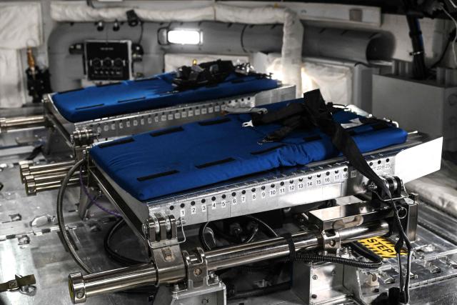 A view through a window of the Orion spacecraft mockup on April 7, 2026 at Johnson Space Center in Houston, Texas. After completing their lunar flyby -- breaking the record for distance from Earth -- the Artemis II crew is bound for home, with splashdown due in the Pacific off the coast of California late April 10. (Photo by RONALDO SCHEMIDT / AFP)