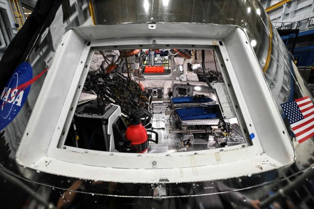 A view through a window of the Orion spacecraft mockup on April 7, 2026 at Johnson Space Center in Houston, Texas. After completing their lunar flyby -- breaking the record for distance from Earth -- the Artemis II crew is bound for home, with splashdown due in the Pacific off the coast of California late April 10. (Photo by RONALDO SCHEMIDT / AFP)