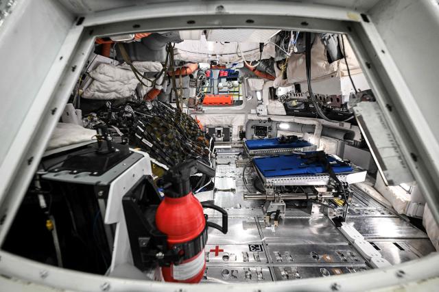 A view through a window of the Orion spacecraft mockup on April 7, 2026 at Johnson Space Center in Houston, Texas. After completing their lunar flyby -- breaking the record for distance from Earth -- the Artemis II crew is bound for home, with splashdown due in the Pacific off the coast of California late April 10. (Photo by RONALDO SCHEMIDT / AFP)