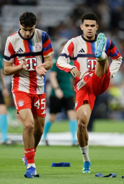 Bayern Munich's German midfielder #45 Aleksandar Pavlovic and Bayern Munich's Colombian forward #14 Luis Diaz warm up before the UEFA Champions League quarter final first leg football match between Real Madrid CF and FC Bayern Munich at Santiago Bernabeu Stadium in Madrid on April 7, 2026. (Photo by Oscar DEL POZO / AFP)