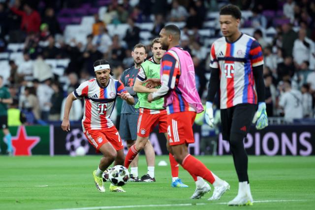 Bayern Munich's German forward #07 Serge Gnabry (L) warms up with teammates before the UEFA Champions League quarter final first leg football match between Real Madrid CF and FC Bayern Munich at Santiago Bernabeu Stadium in Madrid on April 7, 2026. (Photo by Pierre-Philippe MARCOU / AFP)
