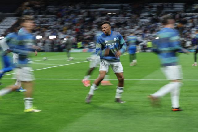 Real Madrid's French forward #10 Kylian Mbappe warms up before the UEFA Champions League quarter final first leg football match between Real Madrid CF and FC Bayern Munich at Santiago Bernabeu Stadium in Madrid on April 7, 2026. (Photo by Thomas COEX / AFP)