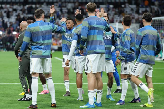 Real Madrid's French forward #10 Kylian Mbappe warms up with teammates before the UEFA Champions League quarter final first leg football match between Real Madrid CF and FC Bayern Munich at Santiago Bernabeu Stadium in Madrid on April 7, 2026. (Photo by Thomas COEX / AFP)