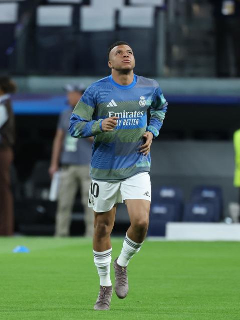 Real Madrid's French forward #10 Kylian Mbappe warms up before the UEFA Champions League quarter final first leg football match between Real Madrid CF and FC Bayern Munich at Santiago Bernabeu Stadium in Madrid on April 7, 2026. (Photo by Thomas COEX / AFP)