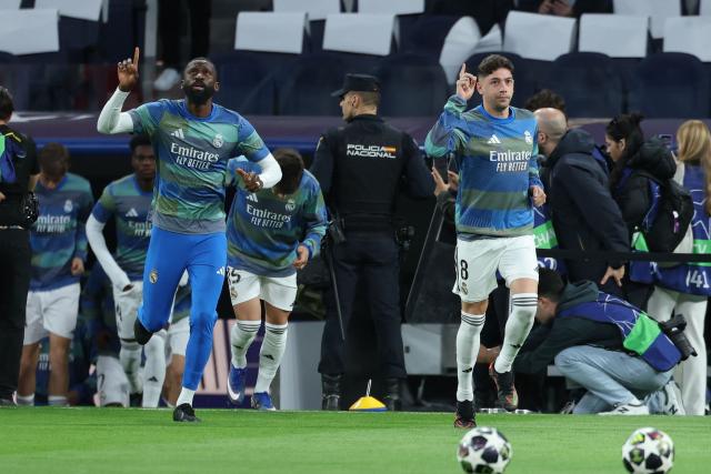 Real Madrid's German defender #22 Antonio Ruediger (L) and Real Madrid's Uruguayan midfielder #08 Federico Valverde warm up before the UEFA Champions League quarter final first leg football match between Real Madrid CF and FC Bayern Munich at Santiago Bernabeu Stadium in Madrid on April 7, 2026. (Photo by Thomas COEX / AFP)