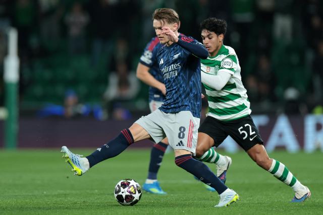 Arsenal's Norwegian midfielder #08 Martin Odegaard and Sporting Lisbon's Portuguese midfielder #52 Joao Simoes fight for the ball during the UEFA Champions League quarter final first leg football match between Sporting CP and Arsenal at Jose Alvalade stadium in Lisbon on April 7, 2026. (Photo by PATRICIA DE MELO MOREIRA / AFP)