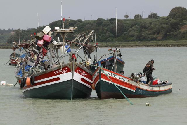 A fisherman from Chelihat, part of a traditional artisanal fishing community, stands on his boat moored offshore in Chelihat, Kenitra region on April 7, 2026. (Photo by Abdel Majid BZIOUAT / AFP)