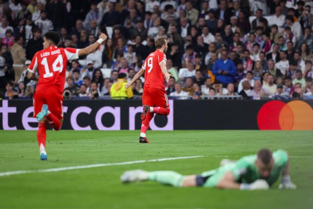 Bayern Munich's English forward #09 Harry Kane (C) celebrates scoring his team's second goal during the UEFA Champions League quarter final first leg football match between Real Madrid CF and FC Bayern Munich at Santiago Bernabeu Stadium in Madrid on April 7, 2026. (Photo by Pierre-Philippe MARCOU / AFP)