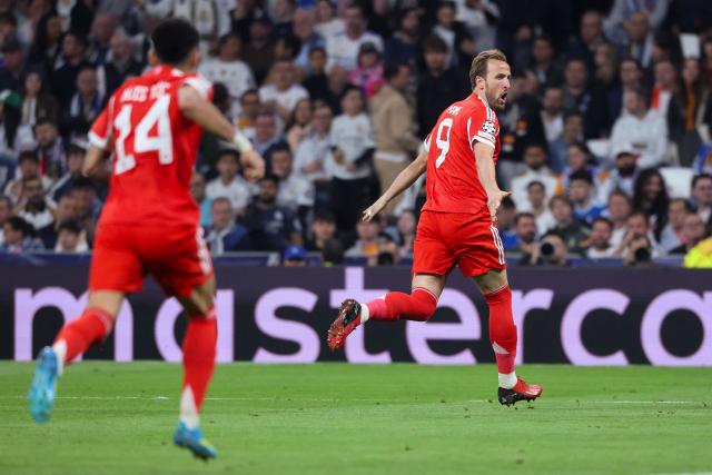 Bayern Munich's English forward #09 Harry Kane (R) celebrates scoring his team's second goal during the UEFA Champions League quarter final first leg football match between Real Madrid CF and FC Bayern Munich at Santiago Bernabeu Stadium in Madrid on April 7, 2026. (Photo by Pierre-Philippe MARCOU / AFP)