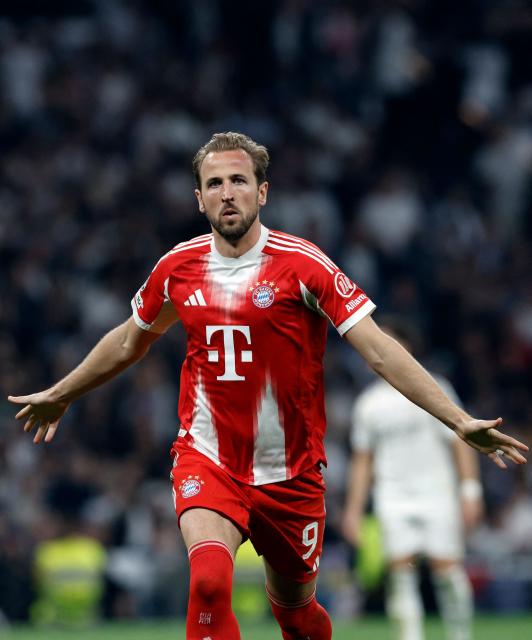 Bayern Munich's English forward #09 Harry Kane celebrates scoring his team's second goal during the UEFA Champions League quarter final first leg football match between Real Madrid CF and FC Bayern Munich at Santiago Bernabeu Stadium in Madrid on April 7, 2026. (Photo by Oscar DEL POZO / AFP)