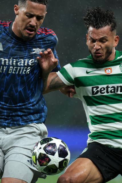 Arsenal's French defender #02 William Saliba (L) and Sporting Lisbon's Colombian forward #97 Luis Suarez fight for the ball during the UEFA Champions League quarter final first leg football match between Sporting CP and Arsenal at Jose Alvalade stadium in Lisbon on April 7, 2026. (Photo by PATRICIA DE MELO MOREIRA / AFP)