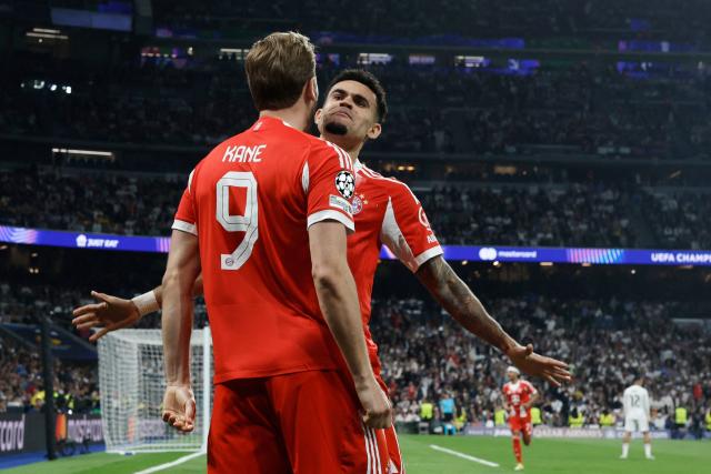 Bayern Munich's English forward #09 Harry Kane celebrates scoring his team's second goal with Bayern Munich's Colombian forward #14 Luis Diaz during the UEFA Champions League quarter final first leg football match between Real Madrid CF and FC Bayern Munich at Santiago Bernabeu Stadium in Madrid on April 7, 2026. (Photo by Oscar DEL POZO / AFP)