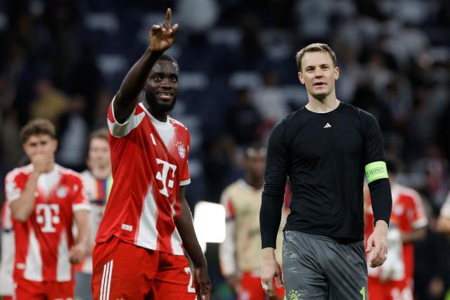 Bayern Munich's German goalkeeper #01 Manuel Neuer and Bayern Munich's French defender #02 Dayot Upamecano celebrate their victory at the end of the UEFA Champions League quarter final first leg football match between Real Madrid CF and FC Bayern Munich at Santiago Bernabeu Stadium in Madrid on April 7, 2026. (Photo by Oscar DEL POZO / AFP)