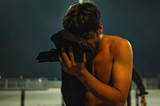 A protester flushes his eyes with liquid after being tear-gassed during a protest outside the Kuwaiti consulate following a strike that killed three people in a nearby town in Basra on April 7, 2026. A strike in Iraq's southern province of Basra on April 7, killed at least three civilians, a provincial councillor and a security official told AFP. A member of Basra's provincial council, said "a house in the city of Khor al-Zubair was struck by what eyewitnesses said was a jet", adding that "neighbours said the house was inhabited by five people, but until now only three bodies have been retrieved". (Photo by Hussein FALEH / AFP)