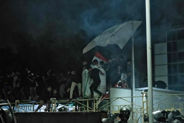 Iraqis protest outside the Kuwaiti Consulate, following a strike that killed three people in a nearby town, in the southern Iraqi city of Basra on April 7, 2026. A strike in Iraq's southern province of Basra on April 7, killed at least three civilians, a provincial councillor and a security official told AFP. A member of Basra's provincial council, said "a house in the city of Khor al-Zubair was struck by what eyewitnesses said was a jet", adding that "neighbours said the house was inhabited by five people, but until now only three bodies have been retrieved". (Photo by Hussein FALEH / AFP)