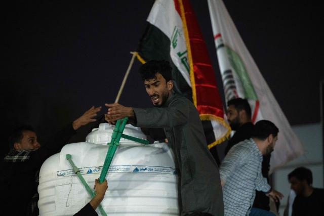 Iraqis hold a protest outside the Kuwaiti Consulate, following a strike that killed three people in a nearby town, in the southern Iraqi city of Basra on April 7, 2026. A strike in Iraq's southern province of Basra on April 7, killed at least three civilians, a provincial councillor and a security official told AFP. A member of Basra's provincial council, said "a house in the city of Khor al-Zubair was struck by what eyewitnesses said was a jet", adding that "neighbours said the house was inhabited by five people, but until now only three bodies have been retrieved". (Photo by Hussein FALEH / AFP)